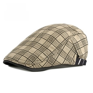 Detailed close-up of light khaki plaid flat cap with adjustable navy strap and metal buckle
