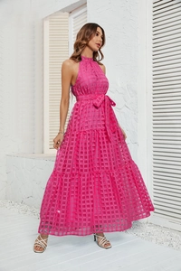 Detailed close-up of pink plaid halter dress with tiered ruffled hem and waist belt