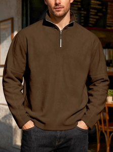 Detail of dark brown men's fleece sweatshirt showing half-zip stand collar and soft texture