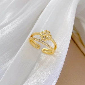 Adjustable four-leaf clover ring with sparkling crystals on gold double-layered band