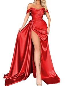 Detailed view of red satin evening gown featuring off-shoulder draped neckline and high slit