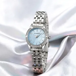 Detail of silver steel men's watch with light blue dial and crystal-encrusted bezel