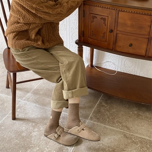 Detail of brown thermal winter socks featuring delicate flower embroidery and ribbed cuff