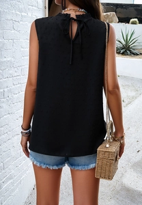 Back view of black sleeveless top with textured fabric and elegant neckline tie