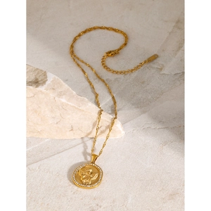18k gold plated stainless steel necklace featuring a crystal angel disc pendant on sand