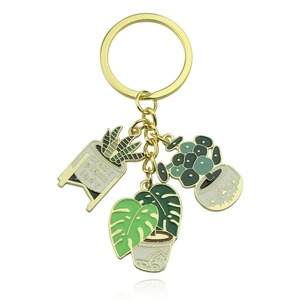 Detail of crazy plant lady succulent keychain with Monstera leaf and enamel plant charms