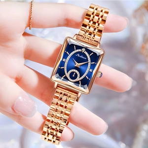 Elegant rose gold square watch for women with a navy blue diamond-set dial on wrist