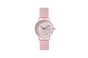 Detail view of pink round dial watch with matching flexible metal expansion band