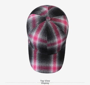 Top-down view showing the symmetrical pink, black, and white plaid pattern of the baseball cap