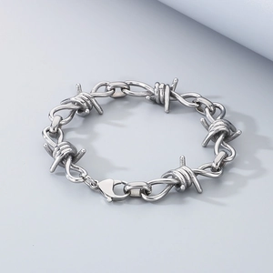 Detailed close-up of a silver thorn bracelet with barbed wire design and lobster clasp