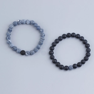 Detailed top view of 8mm beaded bracelets with blue veined agate and matte black lava stone