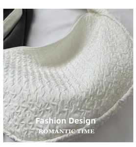 Detail shot showing the white pleated texture and high-quality 3D embossed fabric of the bag
