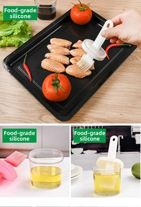 Silicone oil brush applying sauce on grilled chicken wings with storage bottle detail