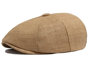 Macro detail of the natural straw weave texture and round top button of the newsboy cap
