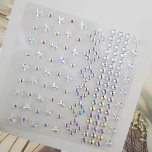 Macro detail of iridescent AB star and round face gems on a clear plastic sheet