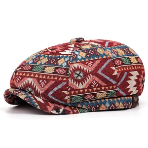 Detailed view of bohemian style newsboy cap with vibrant geometric woven patterns
