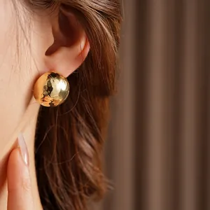 Textured gold domed stud earrings with a hammered finish for a minimalist vintage look