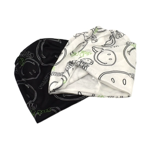 Street style knit beanie with graffiti smiley face and CRAZY print in black and white