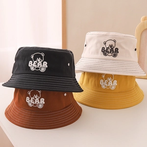 Cute kids bucket hats with bear embroidery in black, cream, yellow, and brown colors