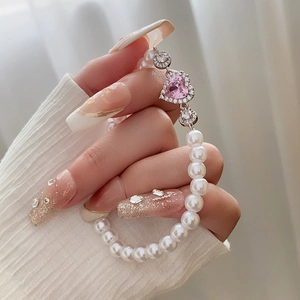 Detail of pink heart zircon and pearls on an elegant elastic bracelet for women