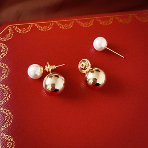 Elegant gold double-sided pearl earrings featuring a metallic ball and pearl design