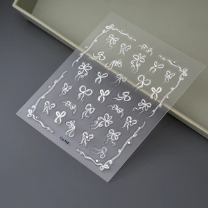 Detail of 5D white bow nail stickers with 3D embossed crystal rhinestones and pearls