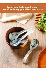 Detail of three blue floral ceramic spoons with long handles in a wooden bowl