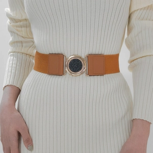 Close-up of a camel elastic corset belt with brown PU leather and gold round buckle