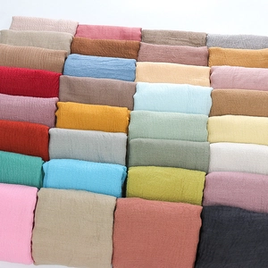 Solid color pleated cotton linen scarf collection featuring fringed edges in various tones
