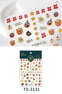 Detailed macro view of 3D embossed cookie party nail art stickers with bear and cupcake motifs
