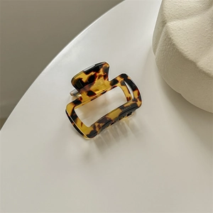 Close-up of a tortoiseshell acetate hair claw clip featuring an hollow square design