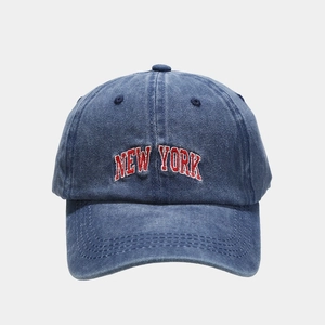 Close-up detail of vintage blue washed denim baseball cap with New York embroidery