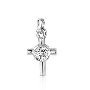 Macro view of a silver cross pendant featuring a centered round cubic zirconia stone