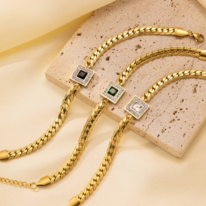 Vintage gold-plated titanium bracelets with emerald-cut crystals on a textured stone base