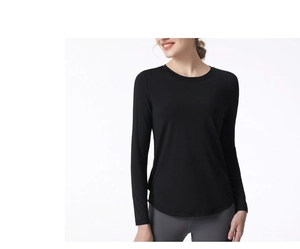 Close-up of women's black yoga long sleeve shirt featuring crew neck and curved hemline