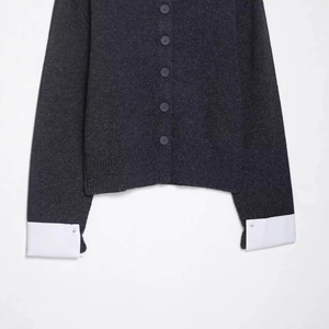 Women's dark gray knit cardigan with stylish contrast white shirt sleeves and buttons