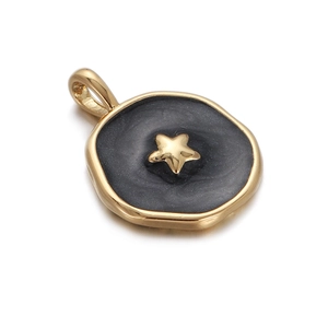 Close-up of a gold star pendant featuring black enamel finish and polished bail hook