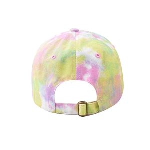 Detail of tie-dye baseball cap back showing adjustable fabric strap and metal buckle
