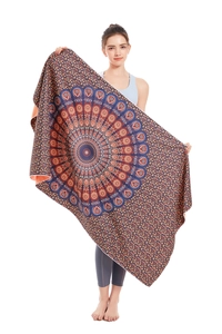 Detail of microfiber beach towel featuring vibrant orange and blue mandala patterns and textures