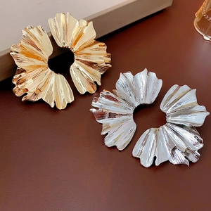 Textured leaf-shaped metal earrings in gold and silver with pleated petal design