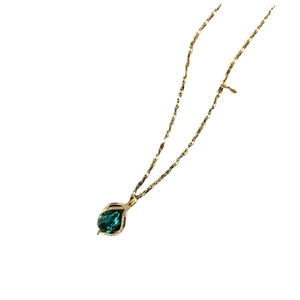 Elegant gold titanium necklace featuring a pear-cut emerald pendant with zircon accents