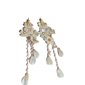 Elegant floral pearl tassel earrings with cascading petals and gold metal accents