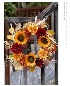 Detail of 45cm autumn wreath with sunflowers and dahlias on a dark metal fence