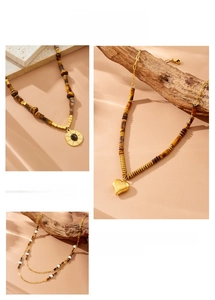 Detail of tiger eye stone necklaces with gold heart charms and layered bead design
