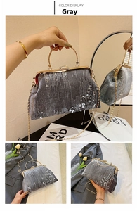 Close-up of grey sequined evening bag with circular metal handle and golden chain strap