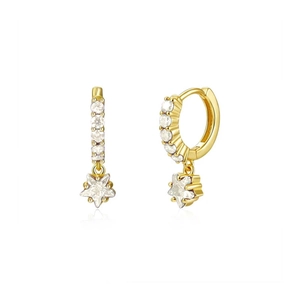 Detailed close-up of golden S925 sterling silver star earrings with clear cubic zirconia