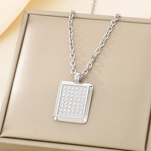 Macro detail of silver rectangular pendant with pavé set sparkling zircon on jewelry box
