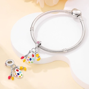 Detailed view of silver charm featuring a colorful paint palette and brushes for bracelets