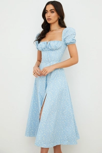 Detail of light blue floral dress showing puff sleeves and high slit hem for summer fashion
