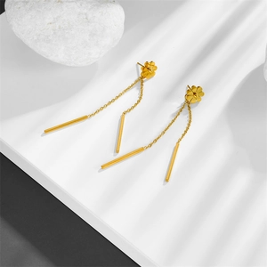Golden stainless steel daisy stud earrings with long tassel chain drops on white surface